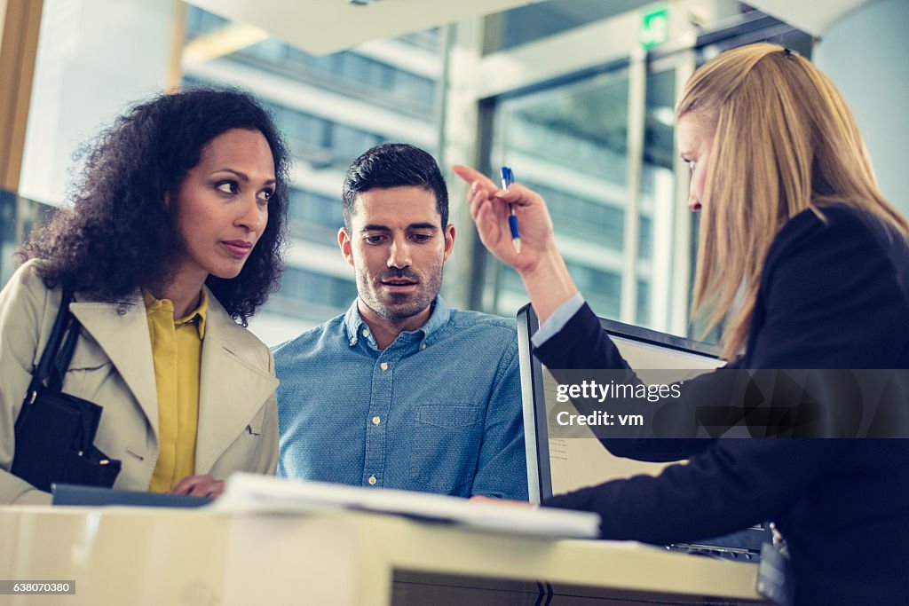 Couple talking to bank employee about loan