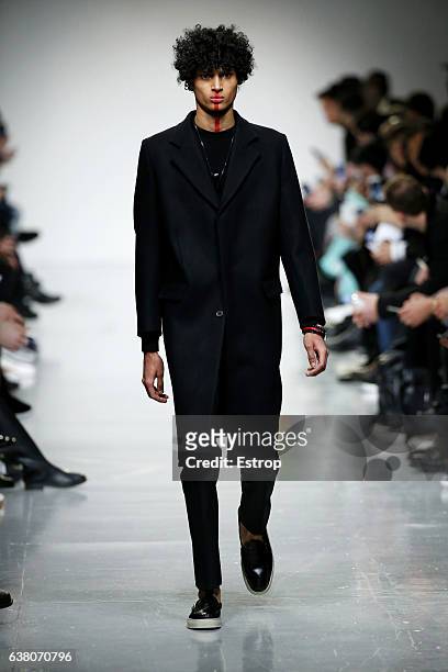 Model walks the runway at the Matthew Miller show during London Fashion Week Men's January 2017 collections at BFC Show Space on January 7, 2017 in...