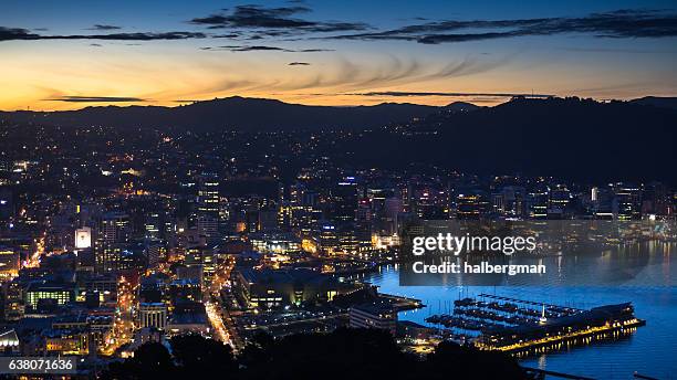 wellington lit up on winter evening - wellington harbour stock pictures, royalty-free photos & images