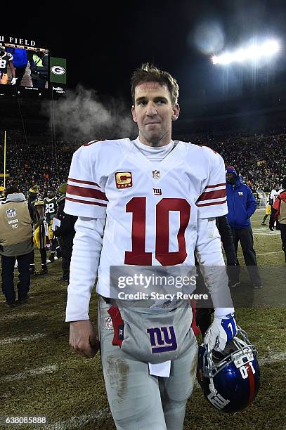 Eli Manning of the New York Giants leaves the field following the NFC Wild Card game against the Green Bay Packers at Lambeau Field on January 8,...