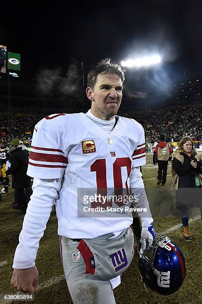 Eli Manning of the New York Giants leaves the field following the NFC Wild Card game against the Green Bay Packers at Lambeau Field on January 8,...
