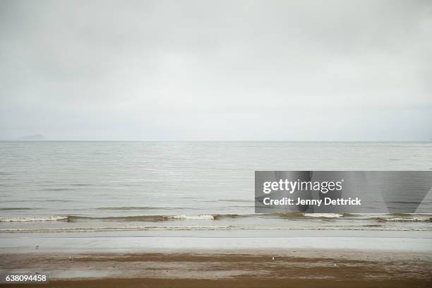 stormy weather on sea horizon - overcast beach stock pictures, royalty-free photos & images