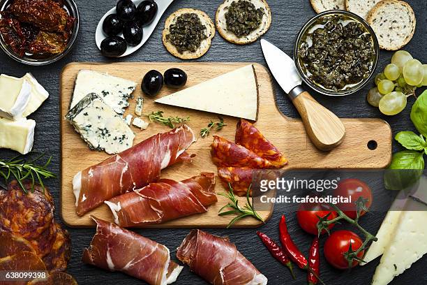 delicious appetizer on dark slate table - chopping board from above stock pictures, royalty-free photos & images