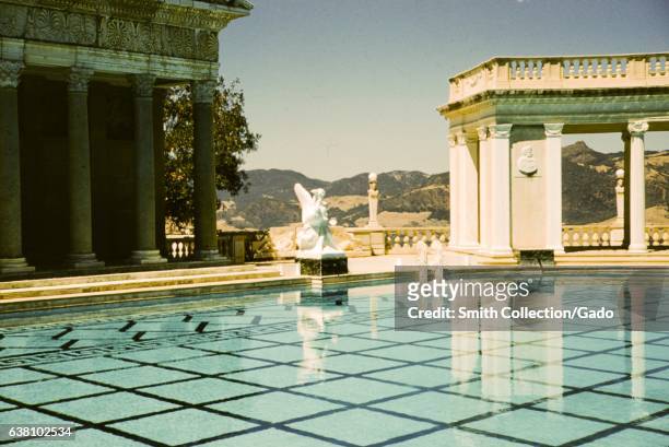 Roman Temple facade, a statue and a marble pavilion sit at the edge of the Neptune Pool at Hearst Castle, San Simeon, California, 1960. .