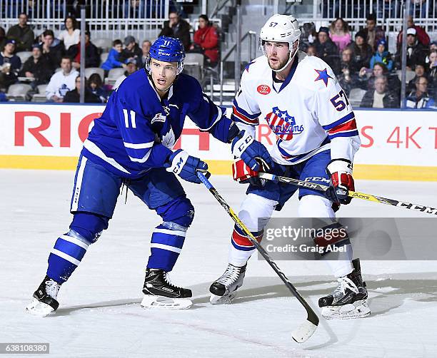 Andreas Johansson of the Toronto Marlies battles with Brady Austin of the Rochester Americans during AHL game action on January 8, 2017 at Ricoh...