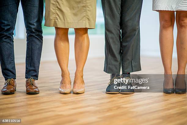 coworkers standing together - smart shoes stock pictures, royalty-free photos & images