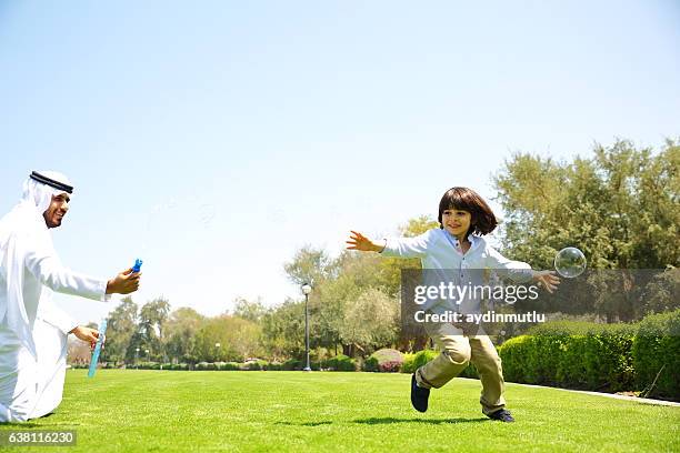father and son - man blowing bubble stock pictures, royalty-free photos & images