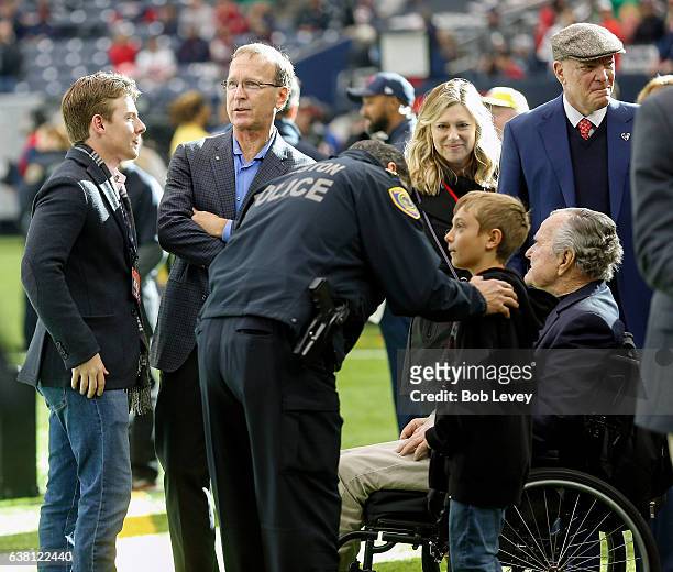 Former President George H.W. Bush, right, along with Neil Bush and Houston Texans owner Bob McNair prior to the AFC Wild Card game at NRG Stadium on...