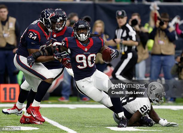 Jadeveon Clowney of the Houston Texans tips and intercepts a pass from Connor Cook of the Oakland Raiders during the first quarter of their AFC Wild...