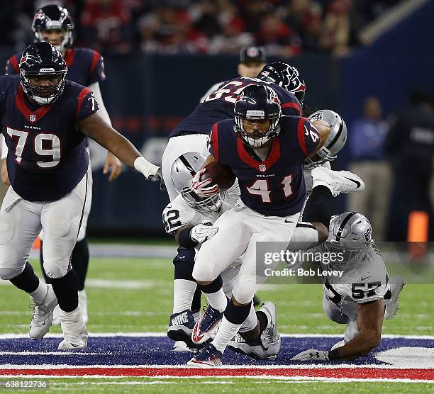 Jonathan Grimes of the Houston Texans breaks the tackle attempt by Karl Joseph of the Oakland Raiders and Cory James in their AFC Wild Card game at...