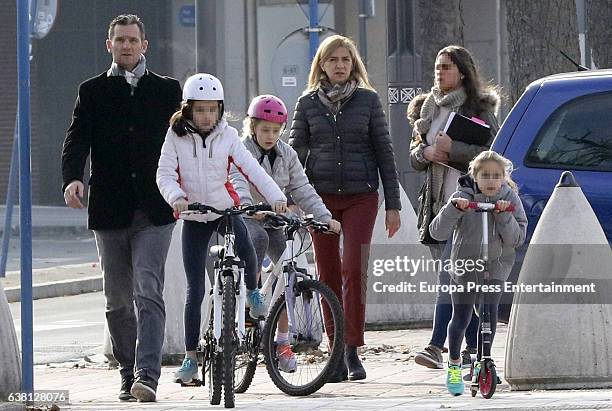 Part of this image has been pixellated to obscure the identity of the child). Princess Cristina of Spain, Inaki Urdangarin, their daughter Irene...