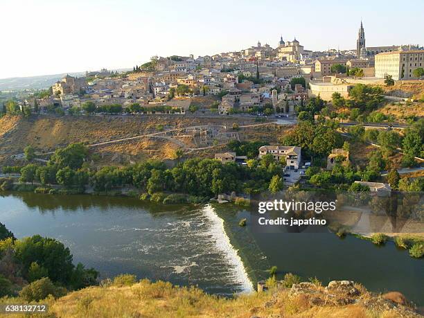 overview of the city of toledo and the tagus river that surrounds the city - alcazar castle stock pictures, royalty-free photos & images