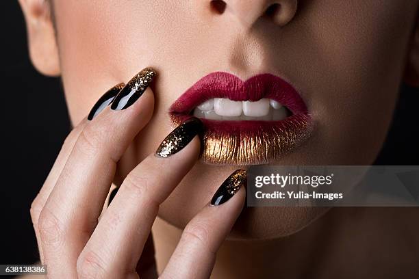 sensual woman with red lipstick touching lips - glitter lips stock pictures, royalty-free photos & images