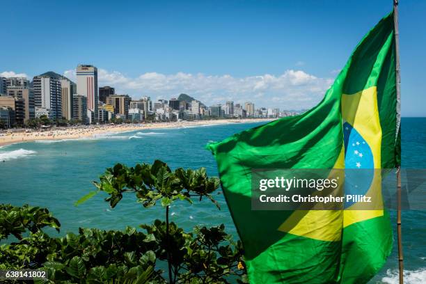 The Brazilian flag flutters in the wind at the end of Leblon and Ipanema beaches in Rio de Janeiro.