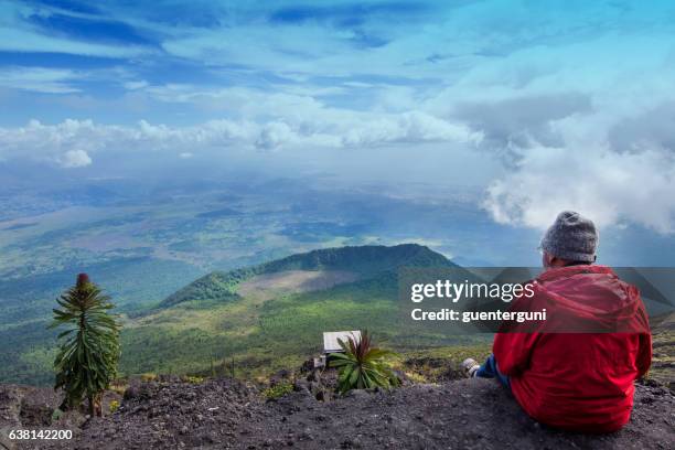 western tourist is sitting at the crater of nyiragongo volcano - virunga national park stock pictures, royalty-free photos & images