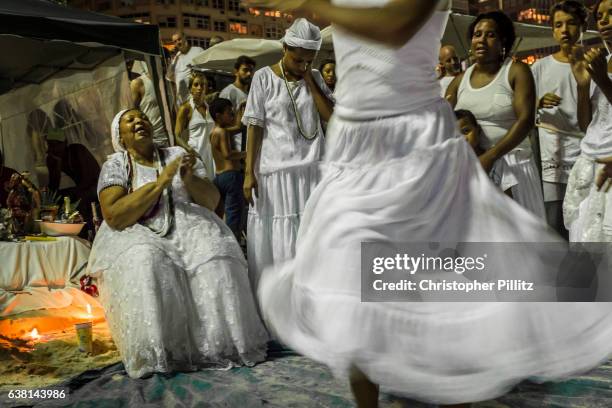 Candomble "priestess" conducts a religious ceremony on Copacabana beach during New Year celebrartions. Candomble originated in Salvador de Bahia in...