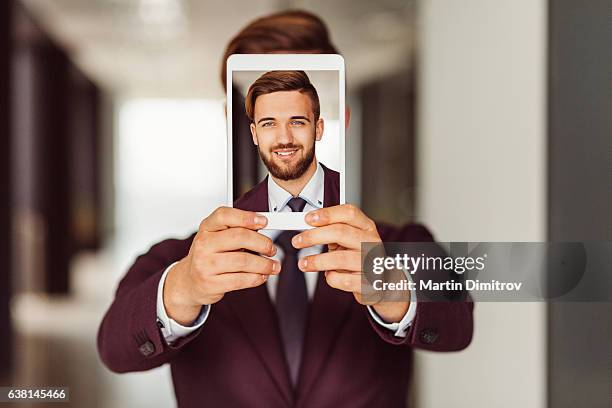 businessman showing selfie on tablet - obscured face phone stock pictures, royalty-free photos & images