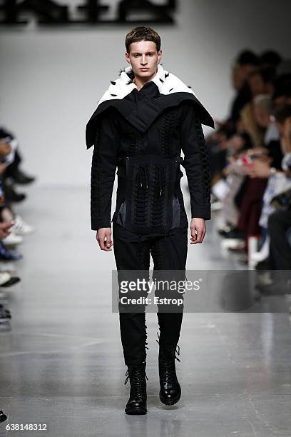 Model walks the runway at the KTZ show during London Fashion Week Men's January 2017 collections at BFC Show Space on January 8, 2017 in London,...