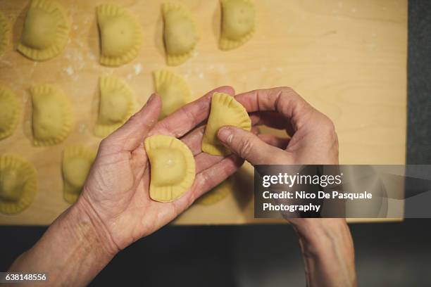 woman making homemade ravioli - ravioli stock-fotos und bilder