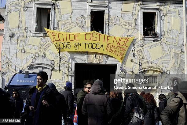 Young people stand by as police look to affect an eviction of a cultural and housing space known as 'Alexis' on January 10, 2017 in Rome, Italy. The...