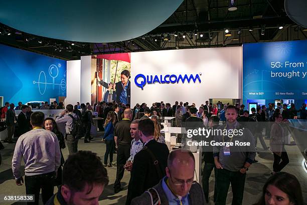 People crowd into the Qualcomm booth to view a series of new products during the annual Consumer Electronics Show on January 4, 2017 in Las Vegas,...