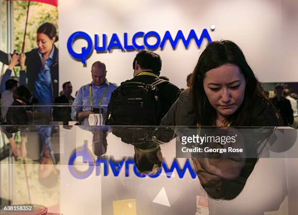 People crowd into the Qualcomm booth to view a series of new products during the annual Consumer Electronics Show on January 4, 2017 in Las Vegas,...