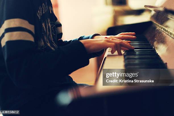 teenage boy playing piano - pianist stockfoto's en -beelden