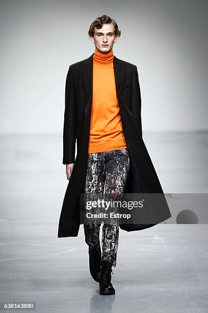 Model walks the runway at the SONGZIO show during London Fashion Week Men's January 2017 collections at BFC Show Space on January 9, 2017 in London,...