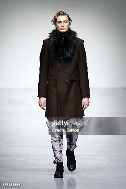 Model walks the runway at the SONGZIO show during London Fashion Week Men's January 2017 collections at BFC Show Space on January 9, 2017 in London,...