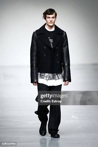 Model walks the runway at the SONGZIO show during London Fashion Week Men's January 2017 collections at BFC Show Space on January 9, 2017 in London,...