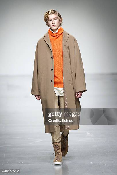 Model walks the runway at the SONGZIO show during London Fashion Week Men's January 2017 collections at BFC Show Space on January 9, 2017 in London,...