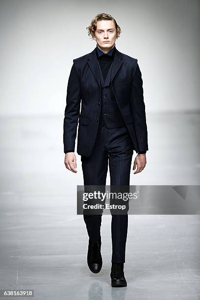 Model walks the runway at the SONGZIO show during London Fashion Week Men's January 2017 collections at BFC Show Space on January 9, 2017 in London,...