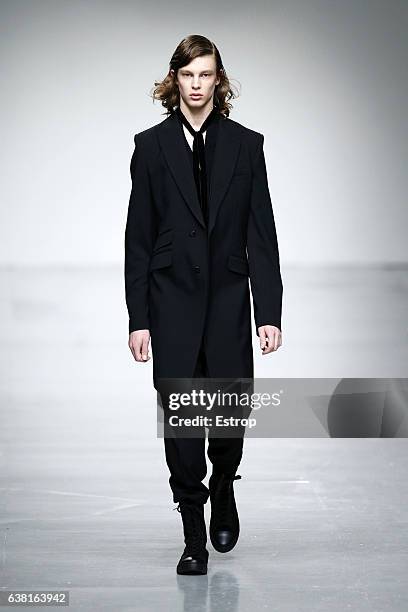 Model walks the runway at the SONGZIO show during London Fashion Week Men's January 2017 collections at BFC Show Space on January 9, 2017 in London,...