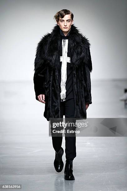 Model walks the runway at the SONGZIO show during London Fashion Week Men's January 2017 collections at BFC Show Space on January 9, 2017 in London,...