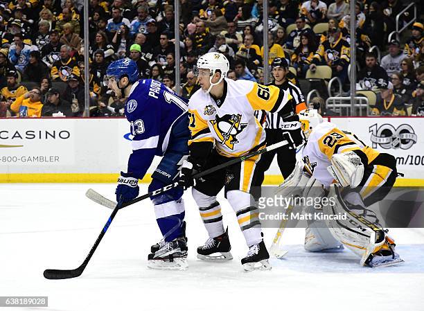 Steven Oleksy of the Pittsburgh Penguins fights for position against Cedric Paquette of the Tampa Bay Lightning at PPG PAINTS Arena on January 8,...
