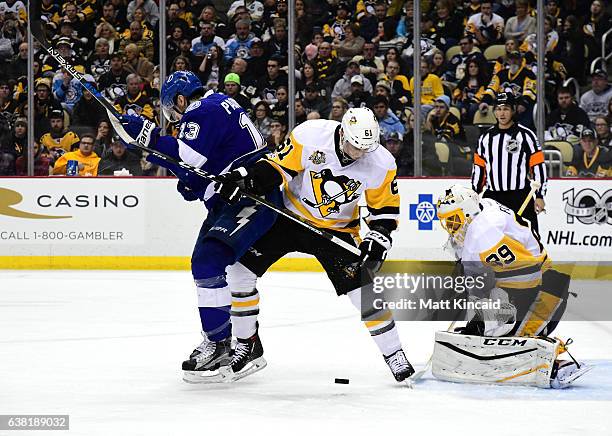 Steven Oleksy of the Pittsburgh Penguins fights for position against Cedric Paquette of the Tampa Bay Lightning at PPG PAINTS Arena on January 8,...