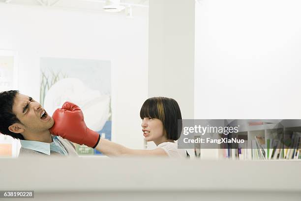 woman hitting man with boxing glove in office cubicle fight - funny boxing bildbanksfoton och bilder