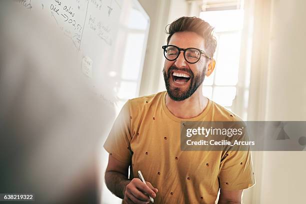 he's the one that brings humour to the team - cheerful businessman stock pictures, royalty-free photos & images