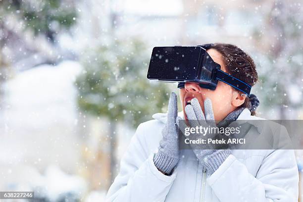 woman using a virtual reality glasses on winter - hands free apparaat stockfoto's en -beelden