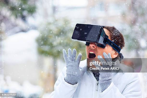 woman using a virtual reality glasses on winter - hands free apparaat stockfoto's en -beelden