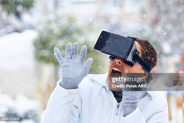 woman using a virtual reality glasses on winter - hands free apparaat stockfoto's en -beelden