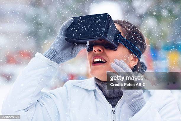 woman using a virtual reality glasses on winter - hands free apparaat stockfoto's en -beelden