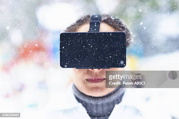 woman using a virtual reality glasses on winter - hands free apparaat stockfoto's en -beelden