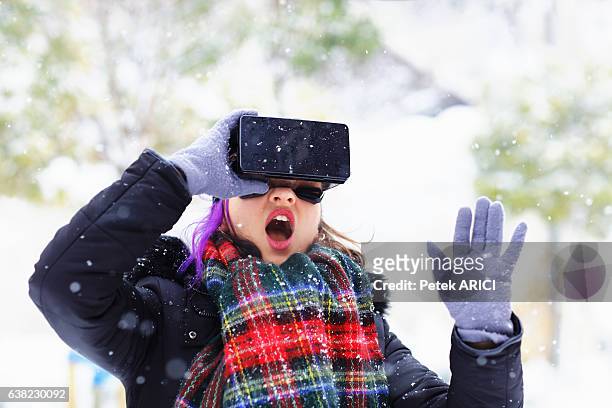 young woman using a virtual reality glasses on winter - hands free apparaat stockfoto's en -beelden
