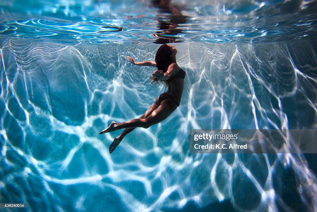 Portrait of a female model underwater in a swimming pool with a in San Diego, California.