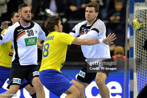 Jens Schoengarth of Germany , Marius Sadoveac of Rumaenien and Erik Schmidt of Germany battle for the ball during the International Handball Friendly...