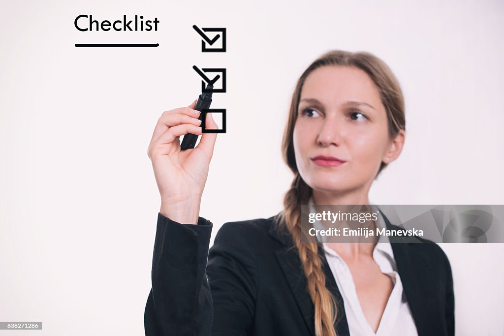 Woman drawing Checklist on board