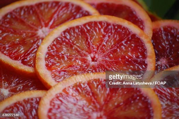 close-up of blood orange slice - blood orange stock pictures, royalty-free photos & images