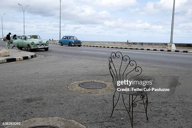 one outside chair at malecon of havana in cuba - malecon stock pictures, royalty-free photos & images