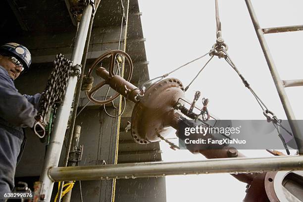 workman working with a crane hoist in boat hull - lead pipe stock pictures, royalty-free photos & images